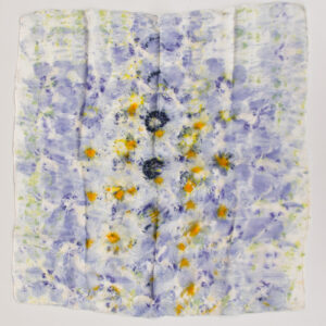 square silk scarf spread out with scattered, abstract pattern of mostly purple flowers some with yellow middle on white background