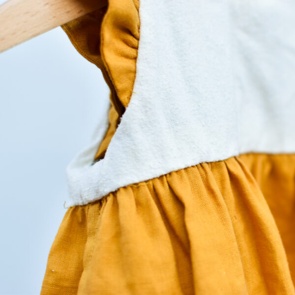 detail of toddler dress inside out to show detail of hand-stitched inner bodice lining and french seams. all hidden seams