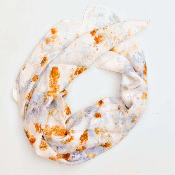 silk scarf draped in a circle, purple and orange images of flowers visible