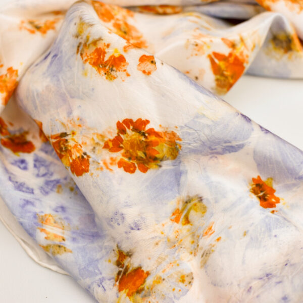 rumpled silk scarf showing orange and purple flower images naturally dyed onto silk