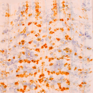spread out square silk scarf with scattered orange and purple flower images created with natural dye technique