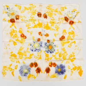 square, silk scarf spread out flat to show images of yellow petals, small orange flowers, and purple cosmos flowers eco-printed into pattern