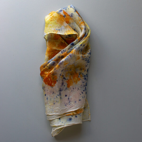 silk scarf with speckled purple and images of orange flowers on white background in pocket scarf fold